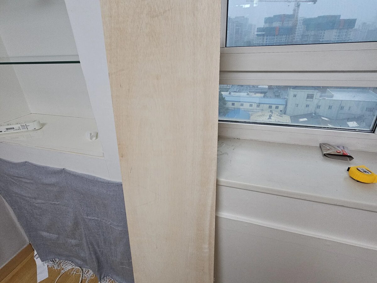 창문 주변 벽면 균열 부위에 합판을 덧대는 과정